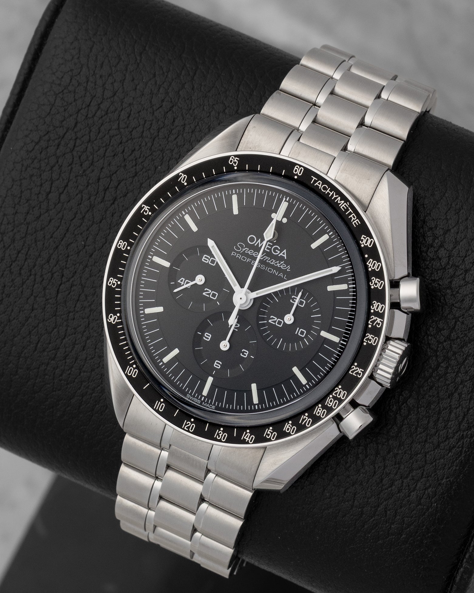 portrait of the 42mm stainless steel Moonwatch case showcasing its black anodized aluminum tachymeter bezel with the historic dot over ninety marker