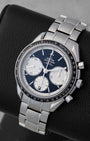 Angled view of Omega Speedmaster 326.30.40.50.01.002 showing black dial, textured white Clous de Paris sub-dials, and tachymeter bezel