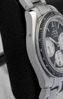 Stainless steel case side profile showing the 10 o'clock quick date corrector button on Omega Speedmaster Racing 40mm