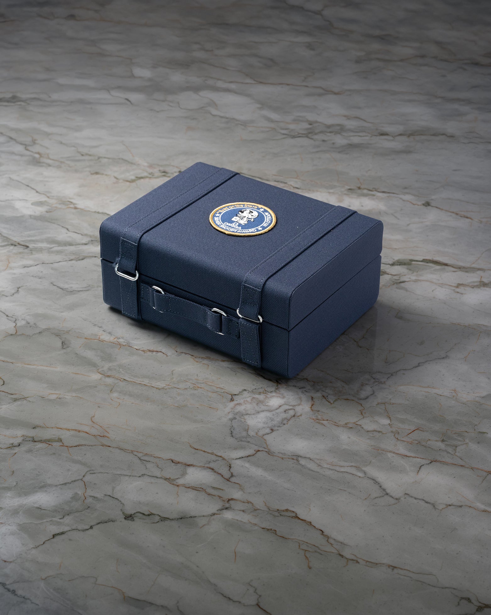Signature blue 50th Anniversary presentation box for Omega Speedmaster Silver Snoopy Award at Noah's Fine Watches & Jewelry