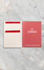 Original Omega red and white warranty card holder included with pre-owned Speedmaster Silver Snoopy Award
