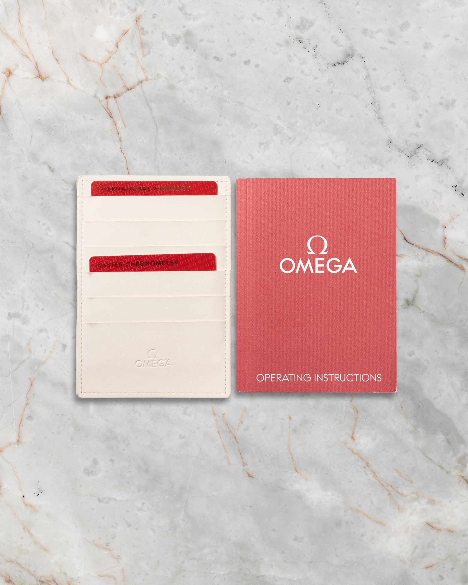 Original Omega red and white warranty card holder included with pre-owned Speedmaster Silver Snoopy Award