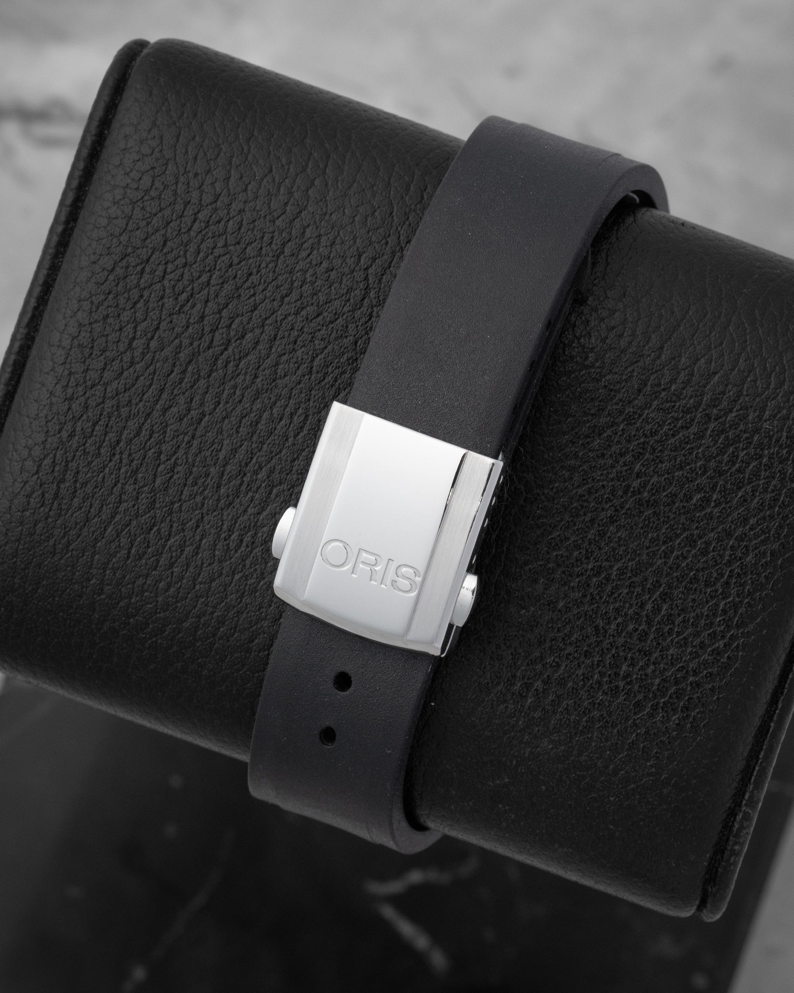 Black rubber Oris sign-molded strap paired with a brushed stainless steel folding security clasp and diver extension buttons