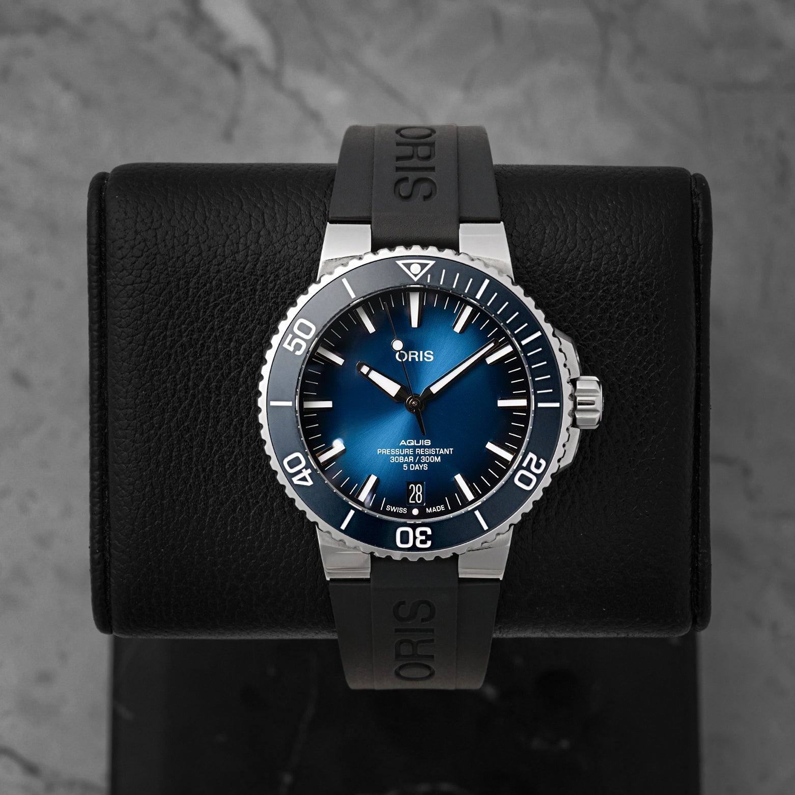 Front portrait of a pre-owned Oris Aquis Date Calibre 400 featuring a gradient blue sunray dial and black rubber strap, available at Noahs Fine Watches and Jewelry Dallas