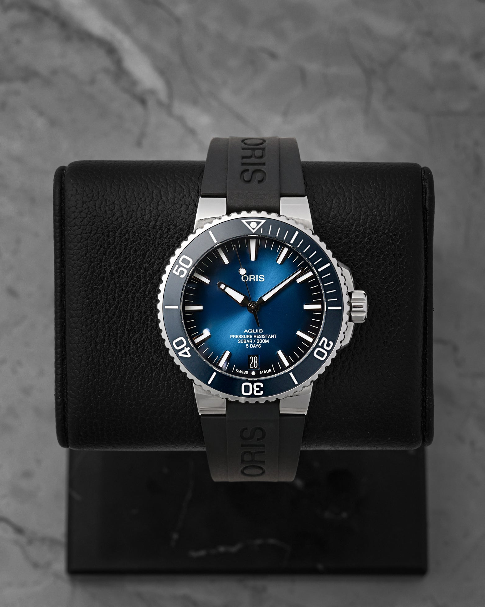 Front portrait of a pre-owned Oris Aquis Date Calibre 400 featuring a gradient blue sunray dial and black rubber strap, available at Noahs Fine Watches and Jewelry Dallas