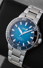 Angled shot of a pre-owned 2022 Oris Aquis Clean Ocean Limited Edition 39.5mm dive watch showing the teal dial and stainless steel multi-link bracelet.