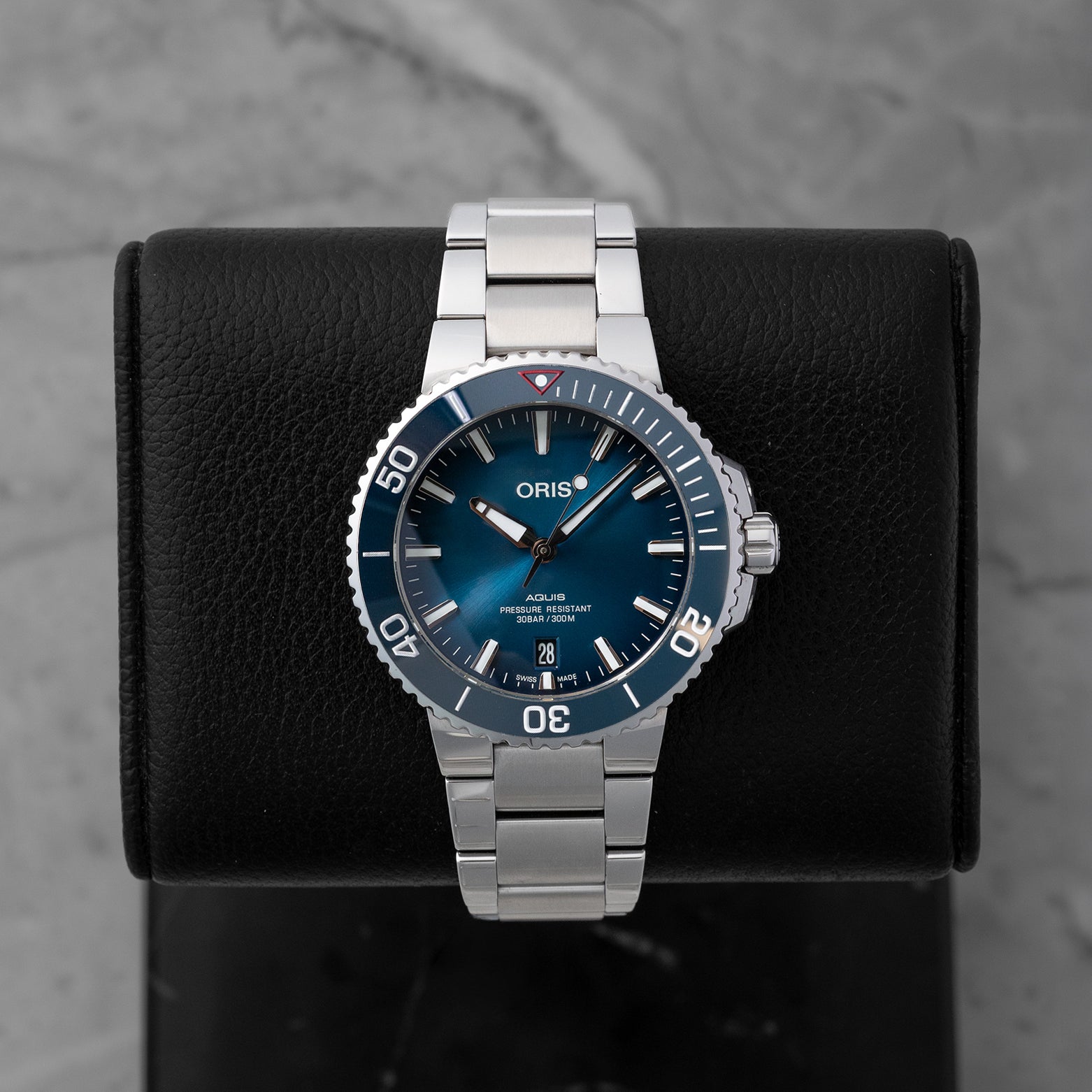 Pre-owned 2022 Oris Aquis Date Clean Ocean Limited Edition reference 01 733 7732 4185 featuring a sunburst aqua blue dial and blue ceramic bezel on display cushion.