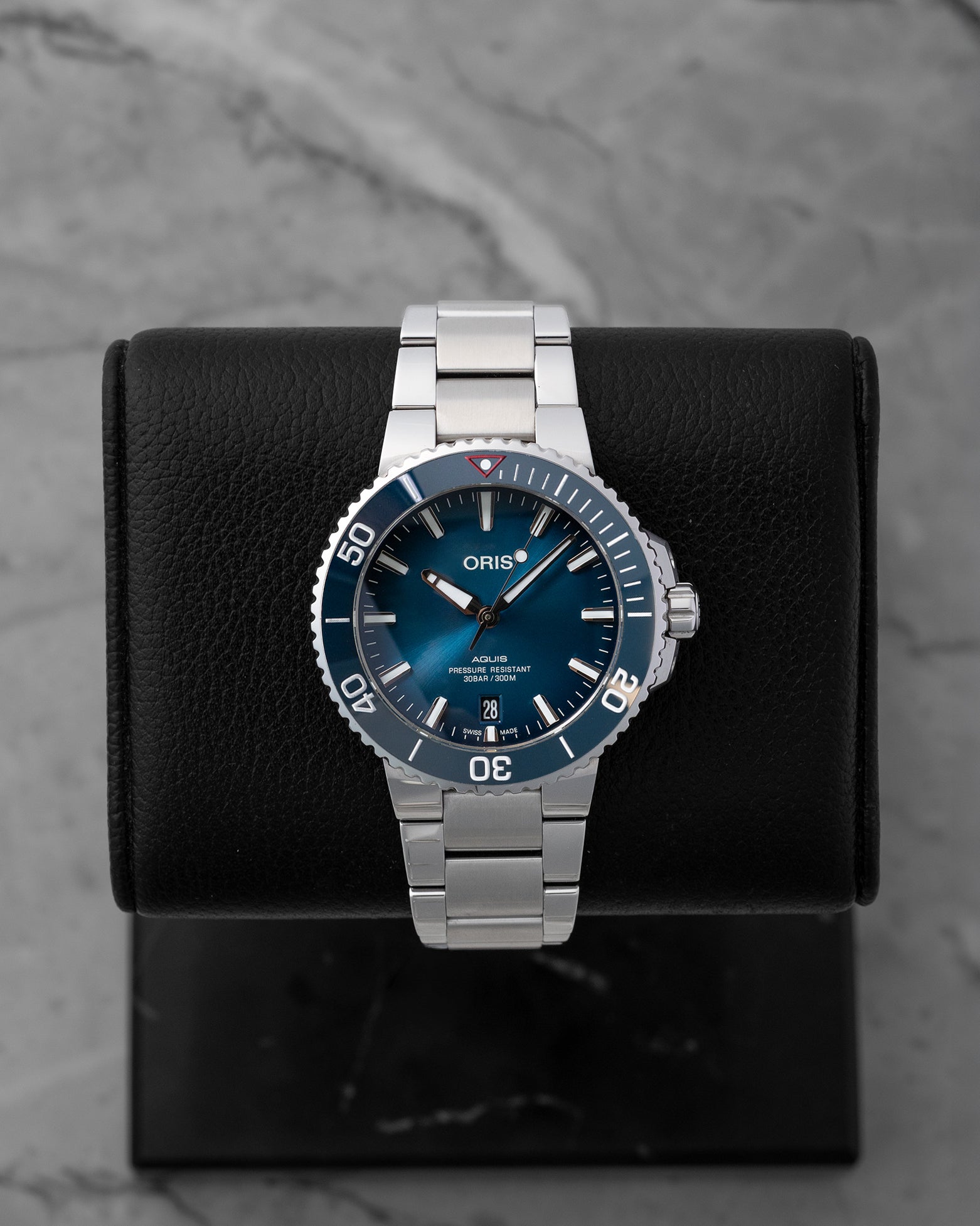Pre-owned 2022 Oris Aquis Date Clean Ocean Limited Edition reference 01 733 7732 4185 featuring a sunburst aqua blue dial and blue ceramic bezel on display cushion.