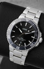 Angled view of 41.5mm Oris Aquis Date showing black sunray dial, luminous indices, and black ceramic bezel