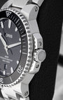 Side profile of 41.5mm stainless steel case showing screw-down crown with crown guards on Oris Aquis Date