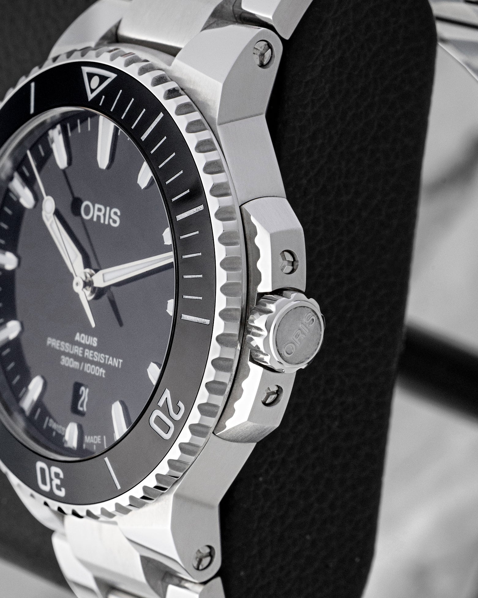 Side profile of 41.5mm stainless steel case showing screw-down crown with crown guards on Oris Aquis Date