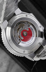 Exhibition mineral glass caseback displaying the signature red rotor on Calibre Oris 733 automatic movement