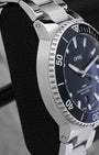 Polished stainless steel case profile and black ceramic bezel view of pre owned Oris Aquis Date