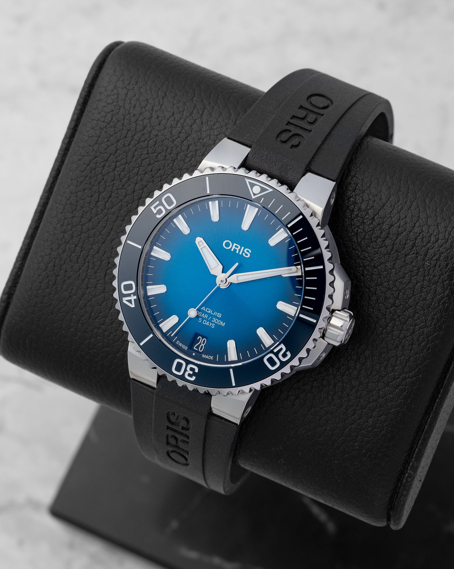 Angled shot of an Oris Aquis Date automatic watch highlighting the bold luminous baton markers and the security crown guards