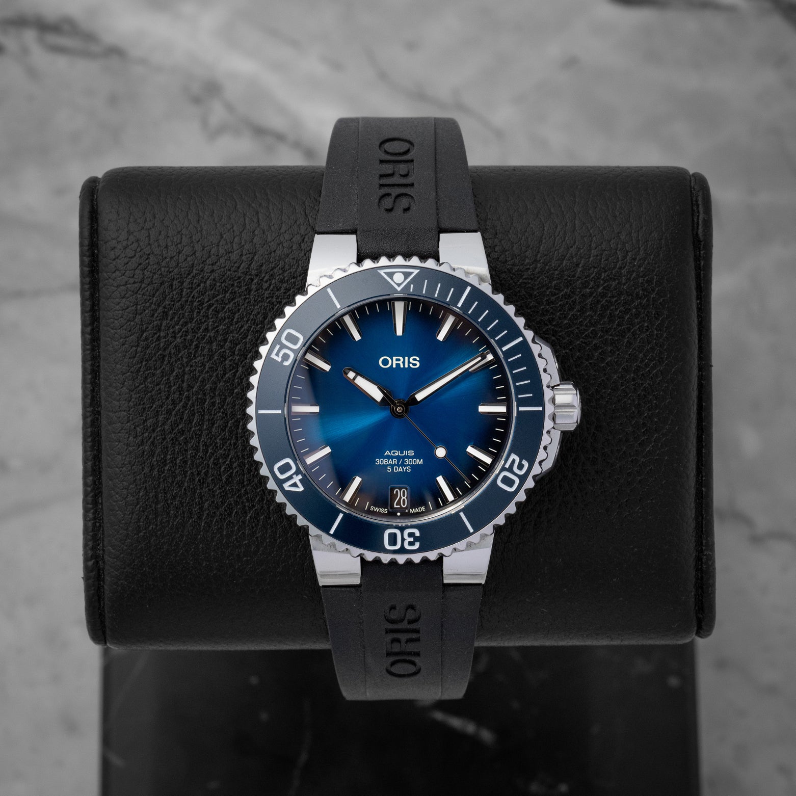 Oris Aquis Date Calibre 400 dive watch featuring a gradient blue sunray dial blue ceramic rotating bezel and a date window