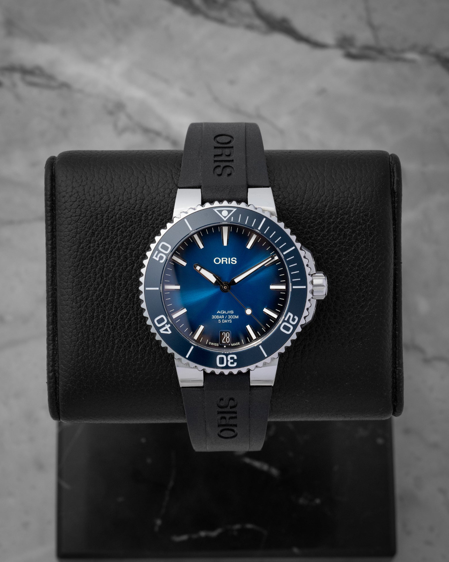 Oris Aquis Date Calibre 400 dive watch featuring a gradient blue sunray dial blue ceramic rotating bezel and a date window