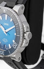 Close-up side profile of the stainless steel Oris watch case showing the chunky screw-down crown with the embossed Oris brand logo