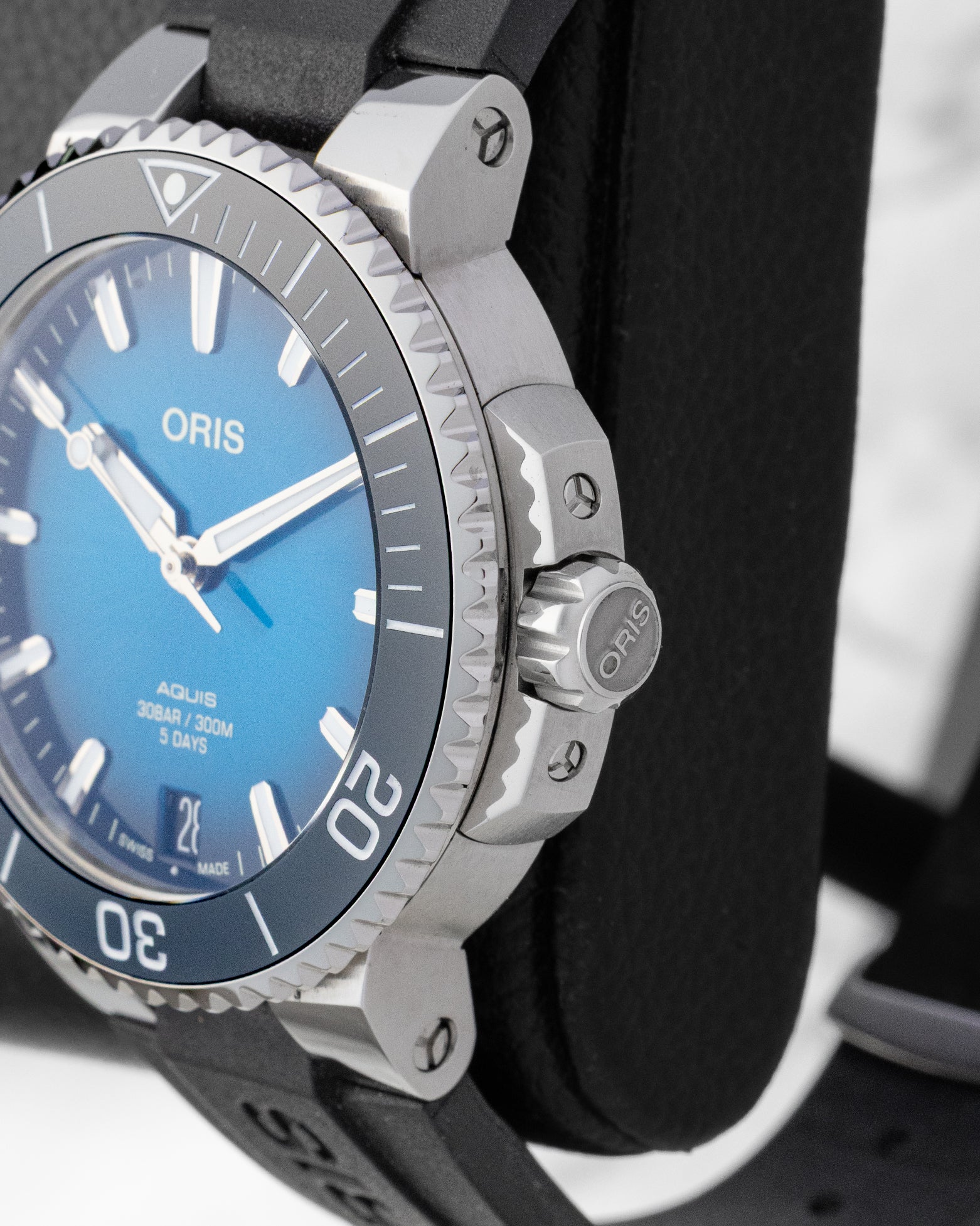 Close-up side profile of the stainless steel Oris watch case showing the chunky screw-down crown with the embossed Oris brand logo