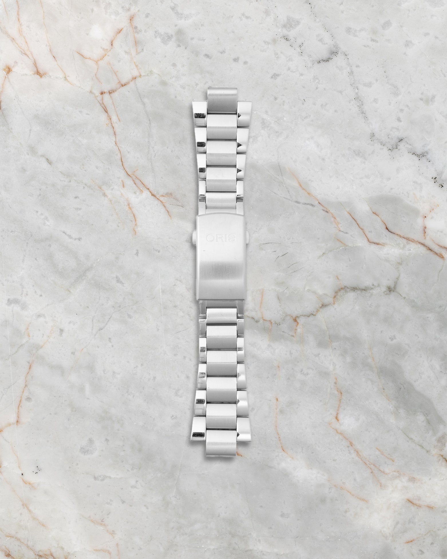 Included extra OEM multi-piece three-link stainless steel metal bracelet featuring the Oris quick-change strap extension mechanism