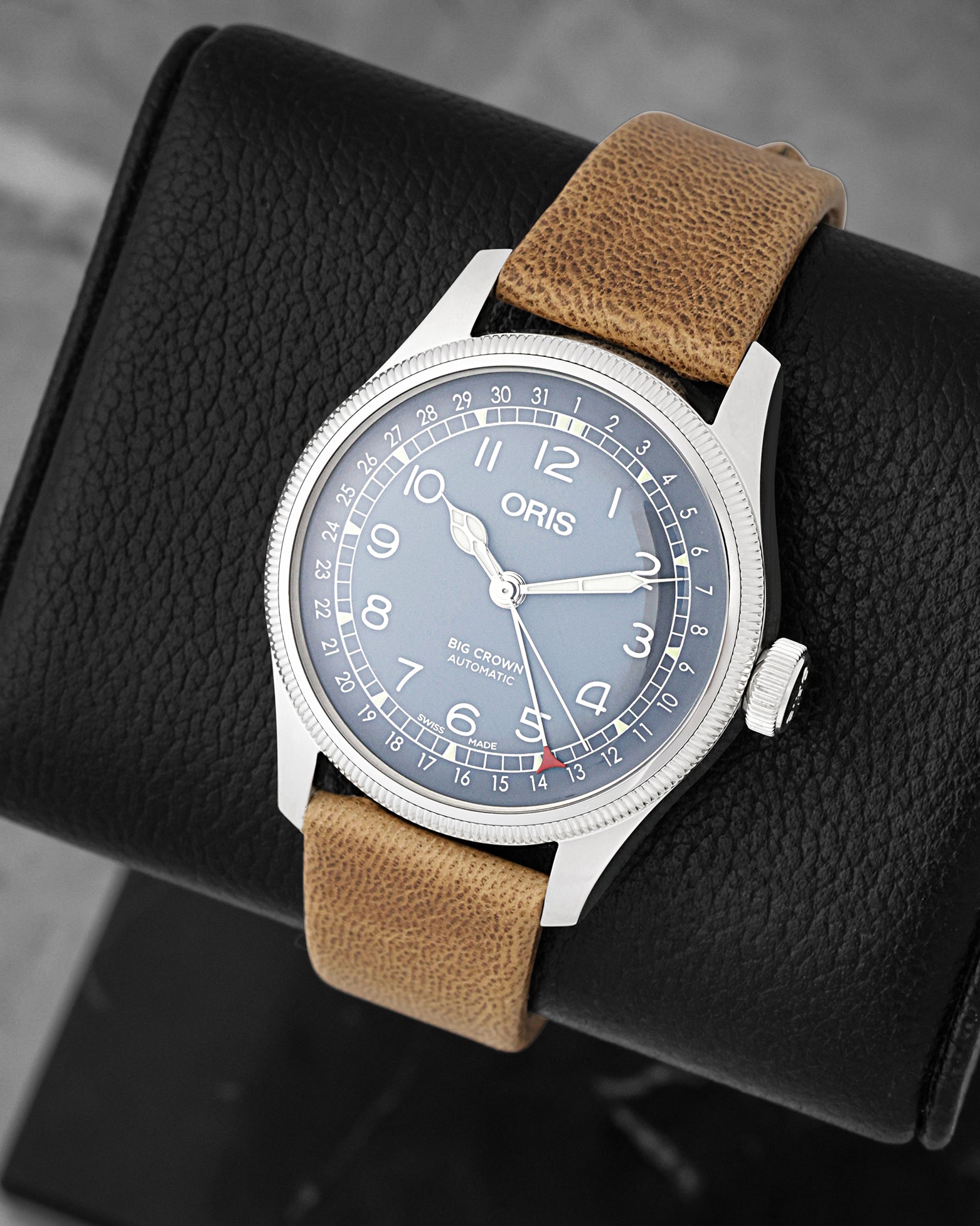 Three-quarter view of Oris Big Crown Pointer Date 4065 featuring a light blue dial, Arabic numerals, and red pointer date hand