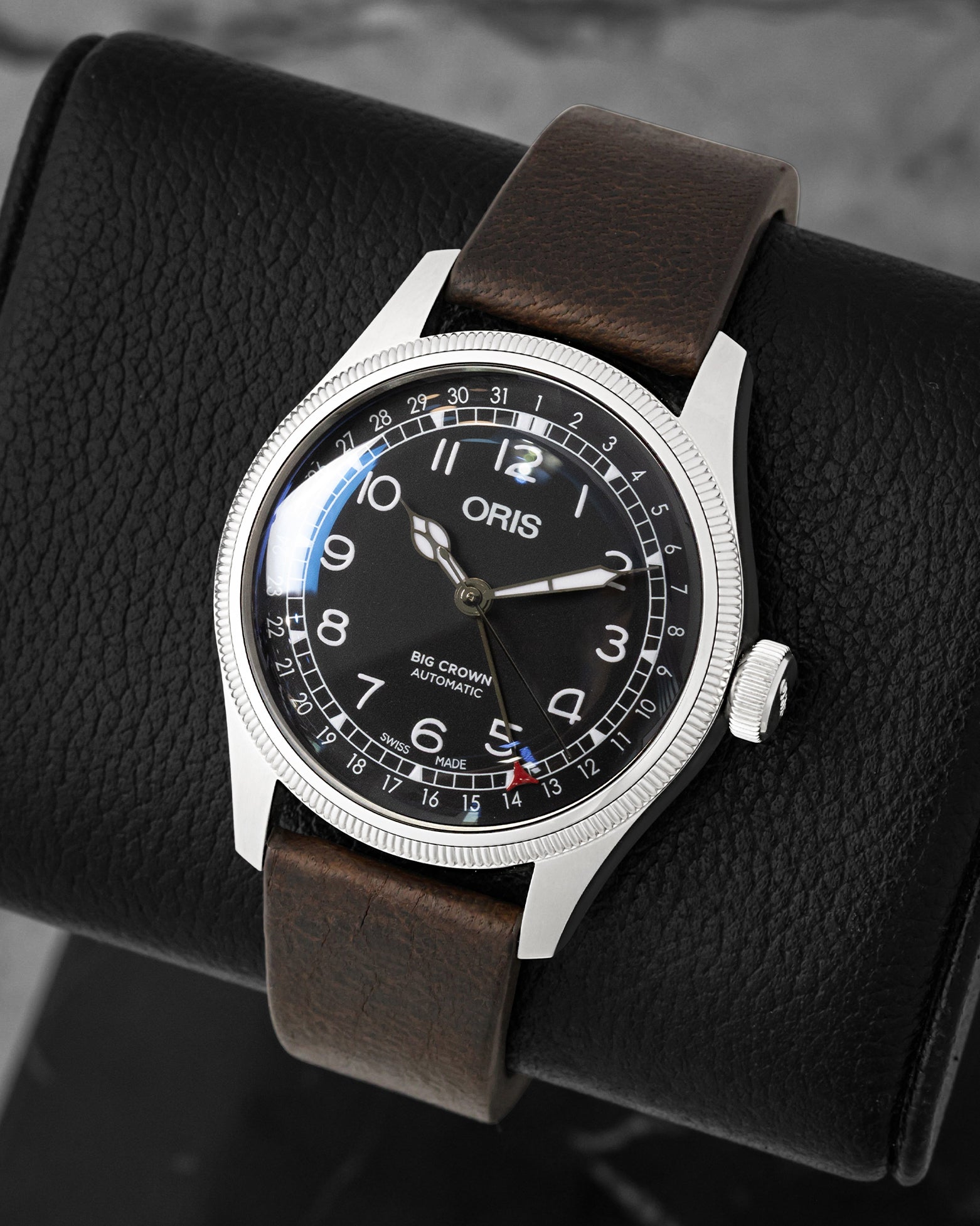 view of Oris Big Crown Pointer Date Waldenburgerbahn showing the black dial, red-tipped date hand, and coin-edge bezel