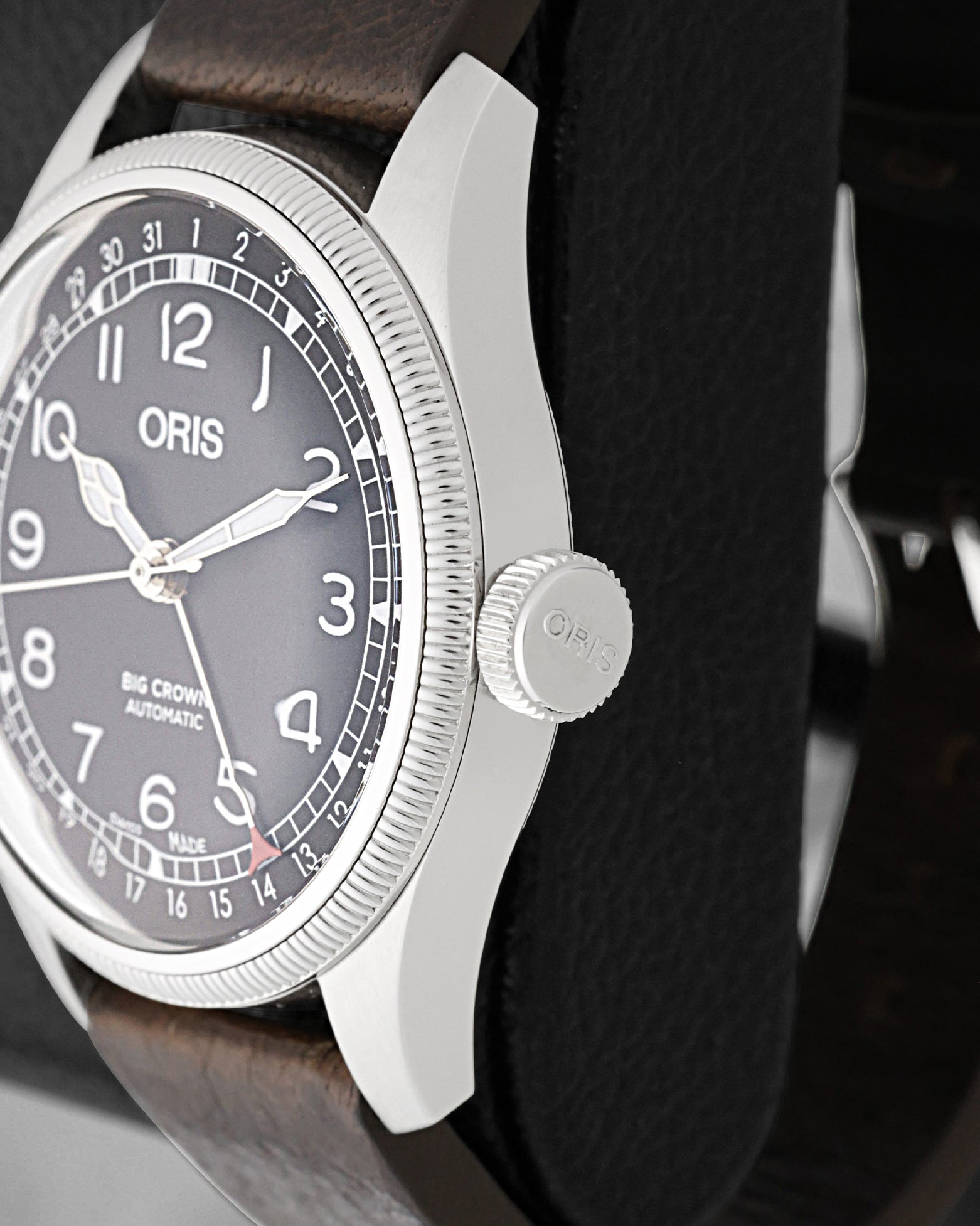 Close-up view of the oversized screw-in crown and fluted bezel on an Oris Big Crown Pointer Date Waldenburgerbahn watch