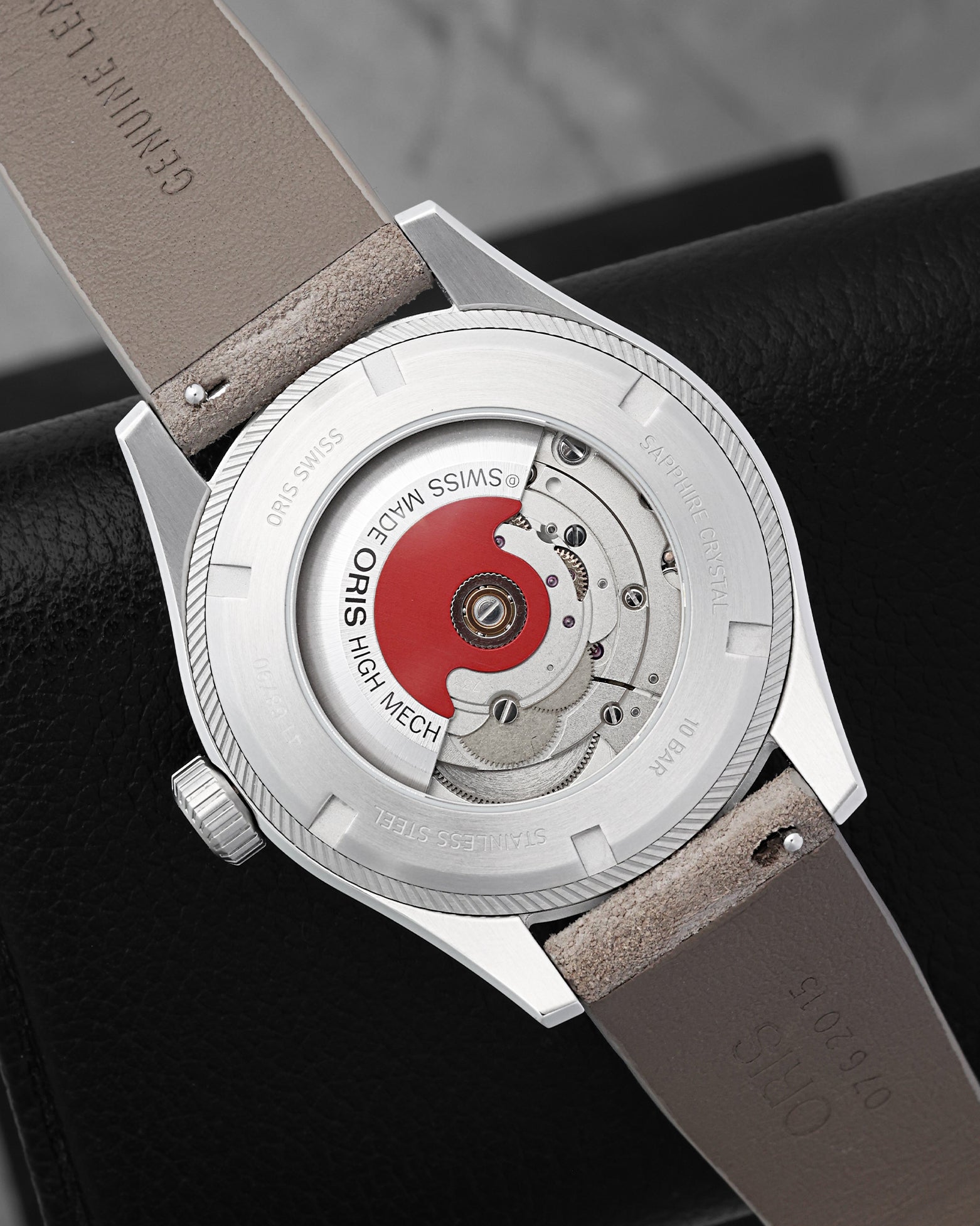 Open sapphire crystal exhibition caseback displaying the Oris Calibre 733 automatic movement and signature Oris Red Rotor