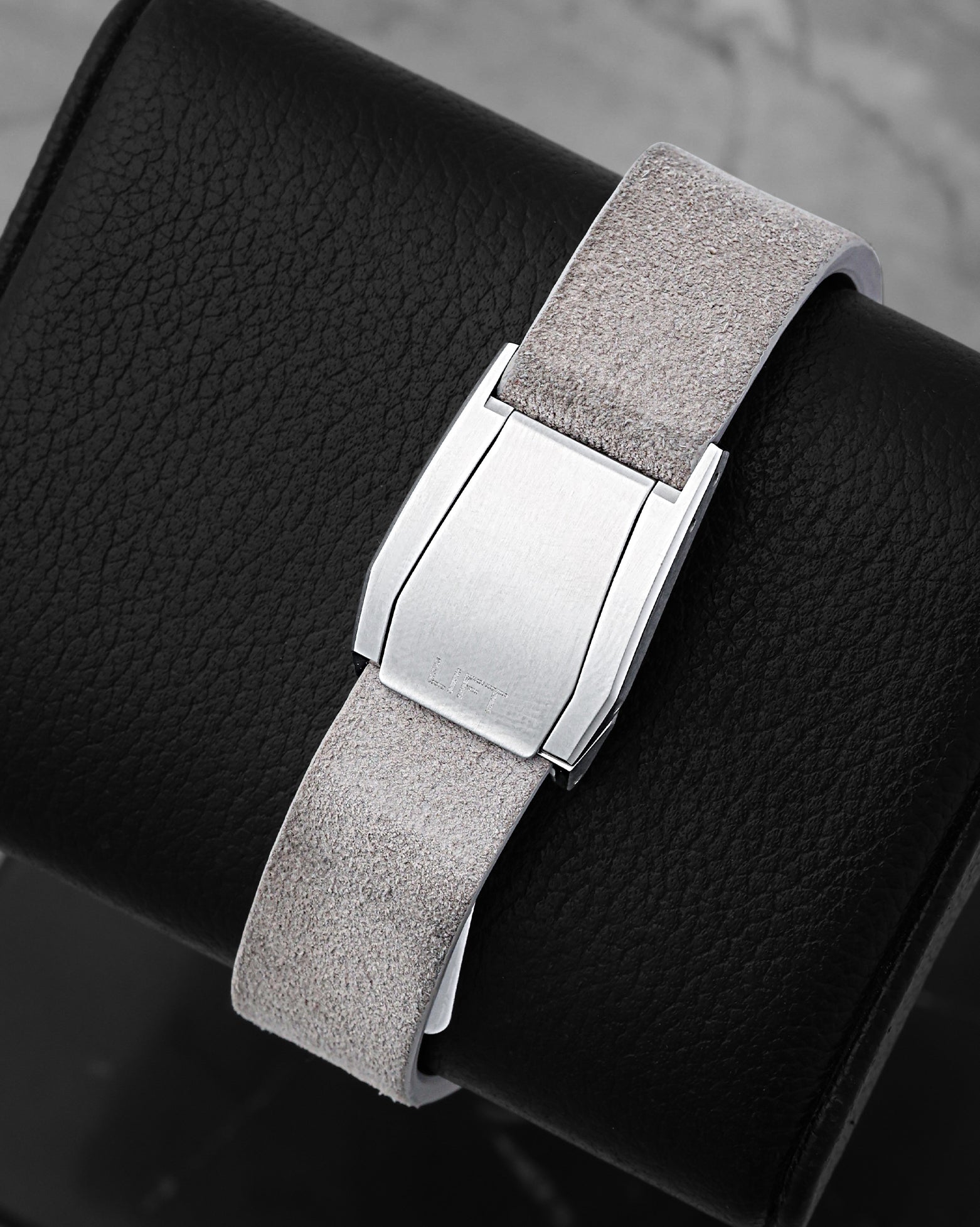 Close-up of the green textile linen strap and custom stainless steel seatbelt-style folding clasp on an Oris watch