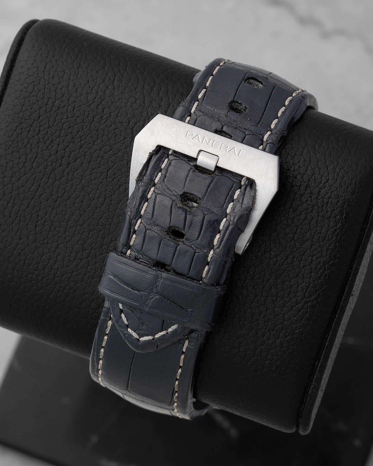 Back view showing the dark alligator leather strap with large brushed stainless steel trapezoid pin buckle on a Panerai PAM00321