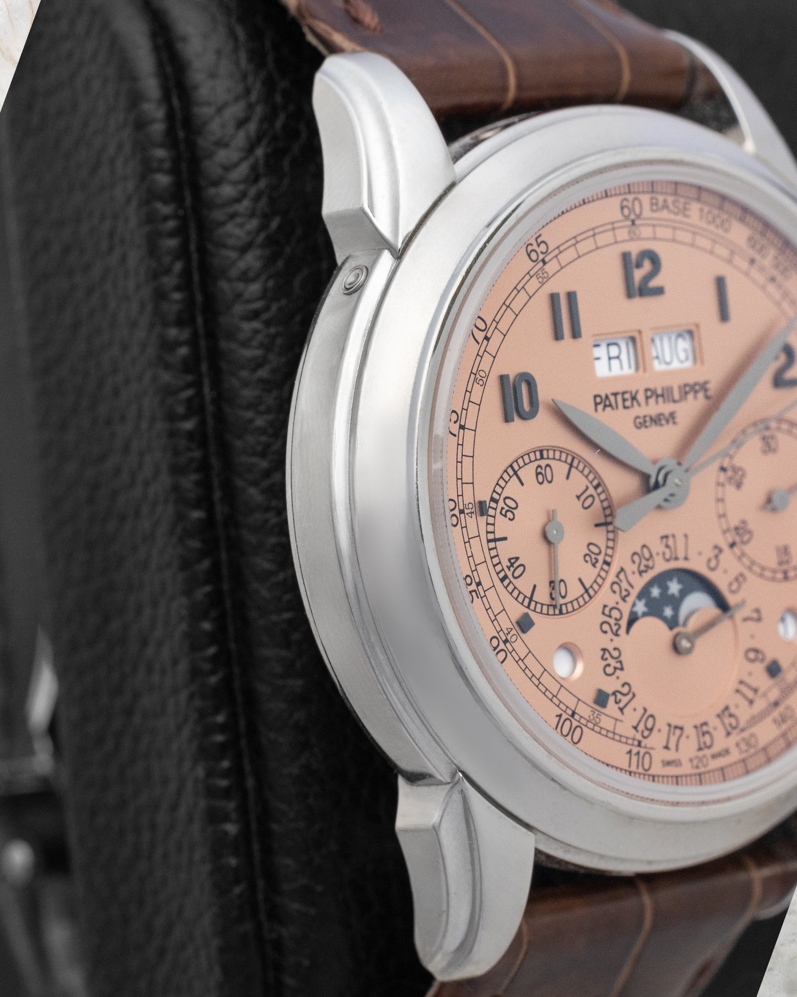 Left side view of the 41mm platinum case on the Patek Philippe 5270P-001, displaying the signature concave bezel and prominent stepped tier lugs