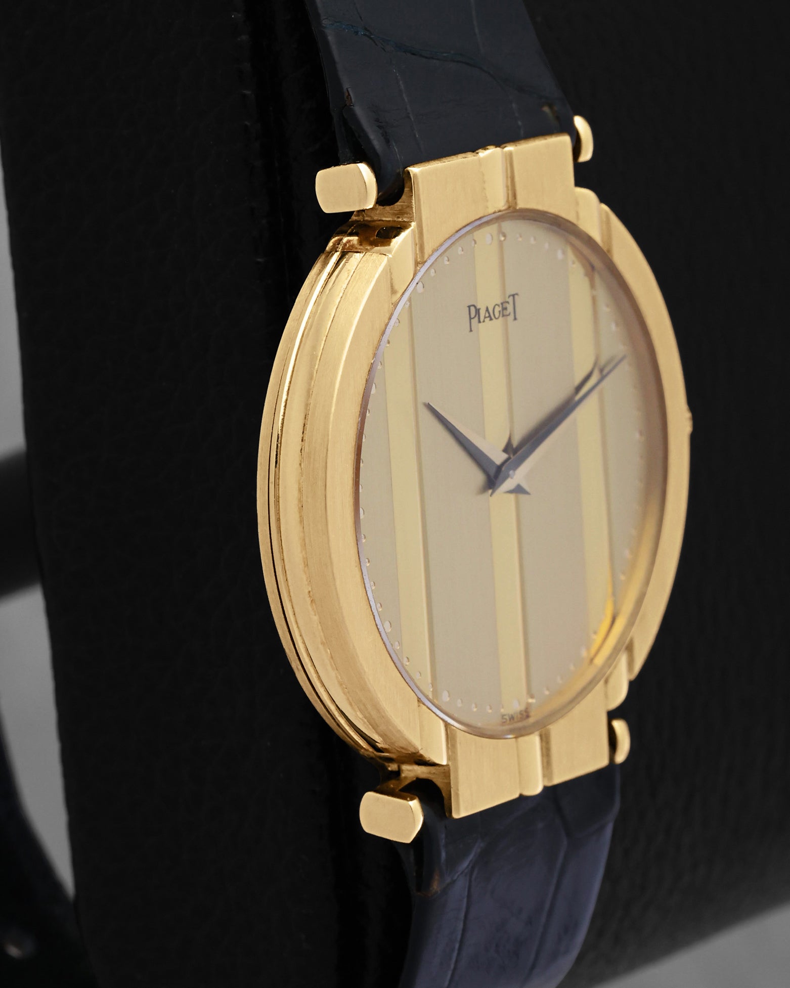 Left side view showcasing the polished 18k yellow gold case steps and smooth bezel finish on a classic Piaget Polo watch