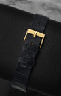 Close-up of the premium blue alligator leather watch strap and matching 18k yellow gold tang buckle