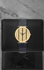 Vintage Piaget Polo 18k yellow gold watch with a striped gold dial, reference 8673, on a blue alligator leather strap at Noah's Fine Watches & Jewelry in Dallas