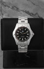 preowned 2006 TAG Heuer Aquaracer 300M reference WAF2110 showcasing its matte charcoal black dial, luminescent stick markers, and signature Arabic numeral 12 index at Noah's Fine Watches & Jewelry in Dallas