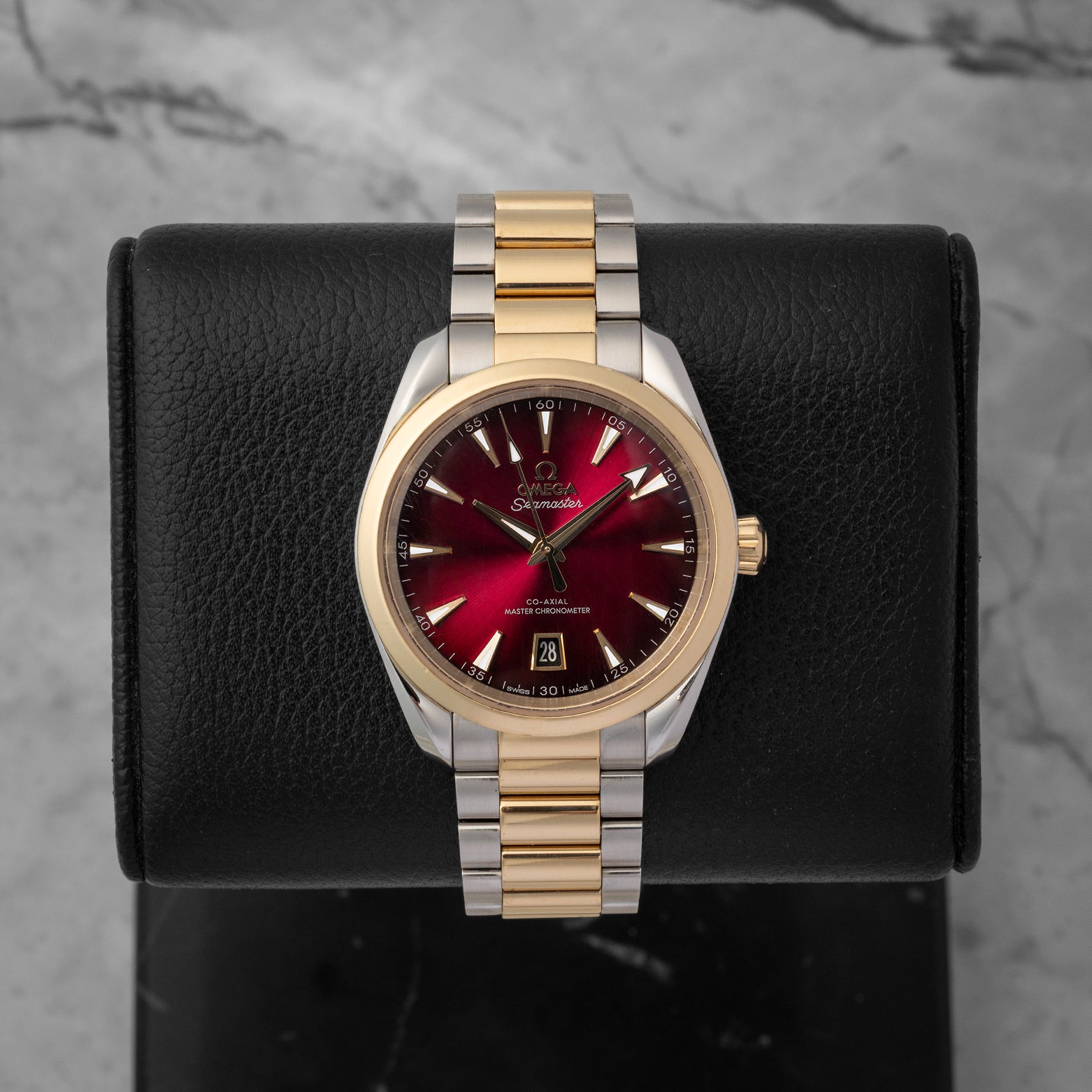 A preowned 2025 Omega Seamaster Aqua Terra 150M reference 220.20.38.20.10.002 displaying its sun-brushed burgundy lacquer dial and 18k Moonshine Gold accents at Noah's Fine Watches & Jewelry in Dallas