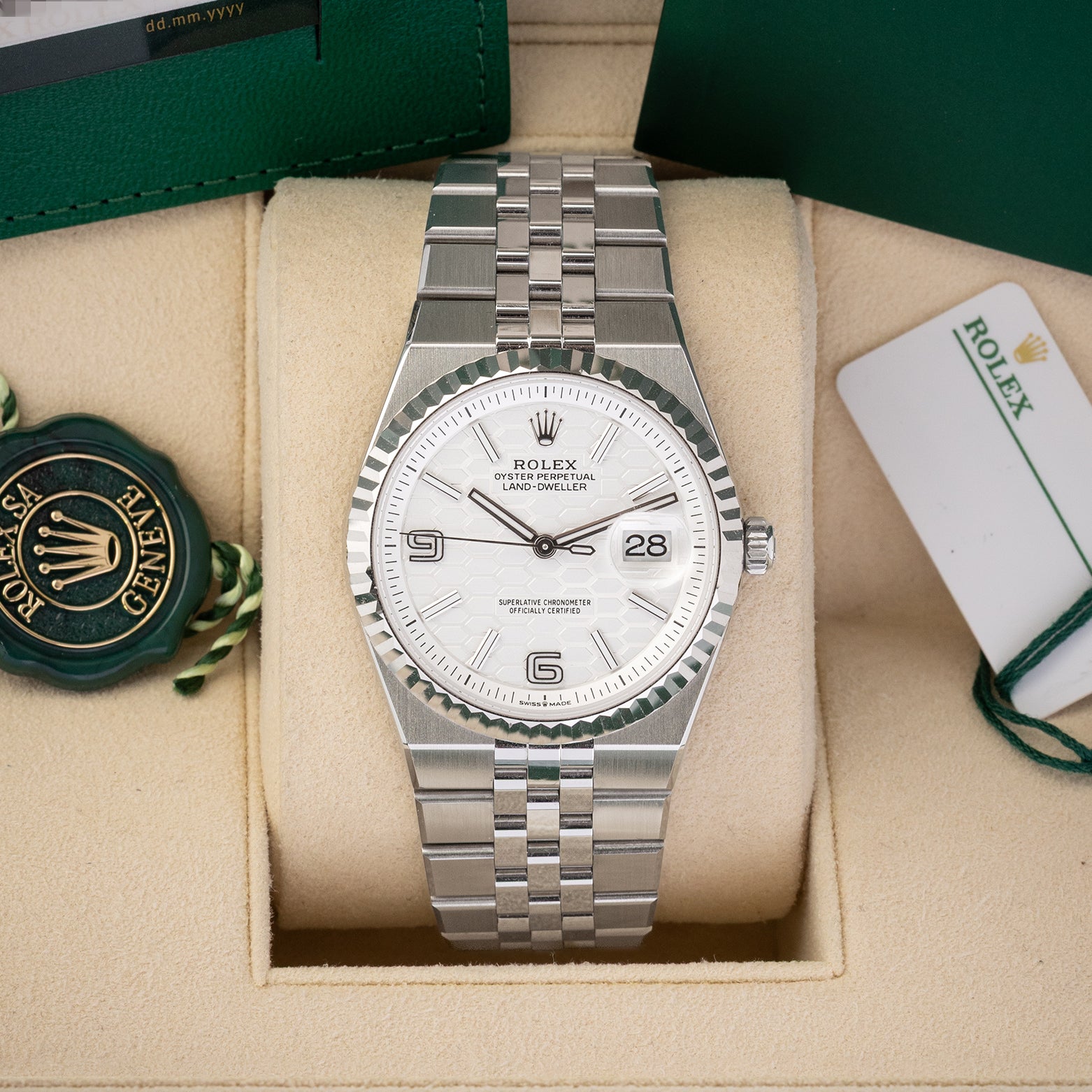A preowned 2025 Rolex Land-Dweller 36 reference 127234 in White Rolesor steel featuring an intense white honeycomb motif dial, fluted bezel, and integrated Flat Jubilee bracelet inside its box at Noah's Fine Watches & Jewelry in Dallas