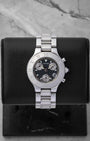 Preowned Cartier Must 21 Chronoscaph W10172T2 ladies stainless steel luxury watch featuring a black logo motif dial and engraved Roman numeral bezel at Noah's Fine Watches and Jewelry in Dallas