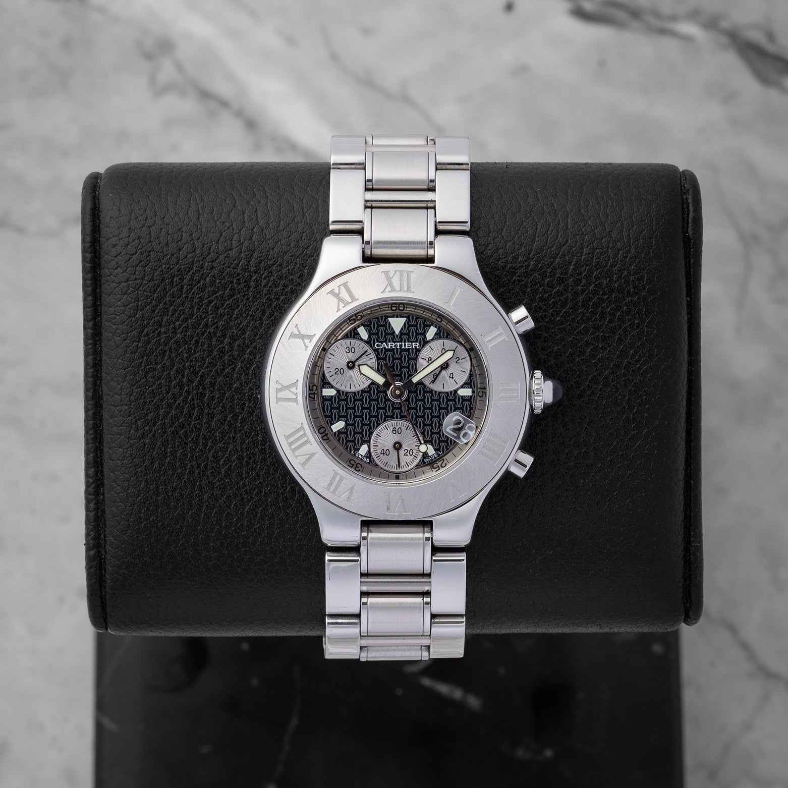 Preowned Cartier Must 21 Chronoscaph W10172T2 ladies stainless steel luxury watch featuring a black logo motif dial and engraved Roman numeral bezel at Noah's Fine Watches and Jewelry in Dallas