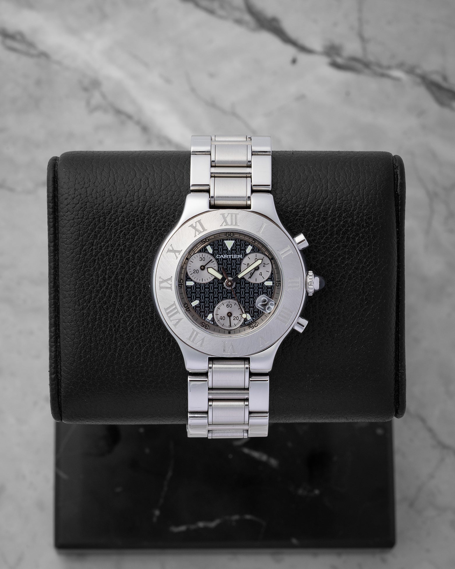 Preowned Cartier Must 21 Chronoscaph W10172T2 ladies stainless steel luxury watch featuring a black logo motif dial and engraved Roman numeral bezel at Noah's Fine Watches and Jewelry in Dallas