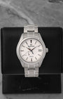A pre-owned Grand Seiko Heritage Collection Snowflake reference SBGA211 showcasing its legendary wind-swept snow textured dial and a heat-blued steel seconds hand at Noah's Fine Watches & Jewelry in Dallas