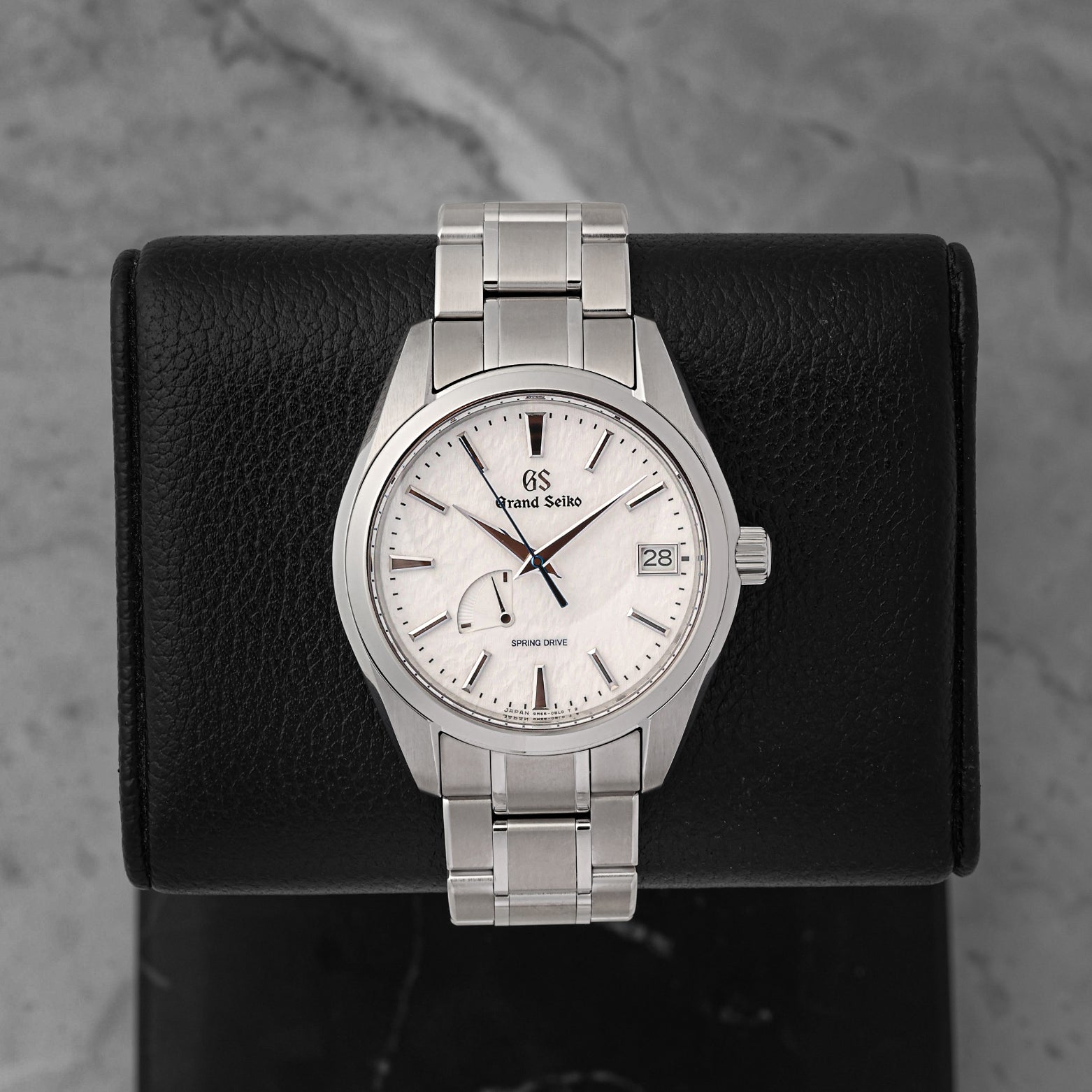 A pre-owned Grand Seiko Heritage Collection Snowflake reference SBGA211 showcasing its legendary wind-swept snow textured dial and a heat-blued steel seconds hand at Noah's Fine Watches & Jewelry in Dallas