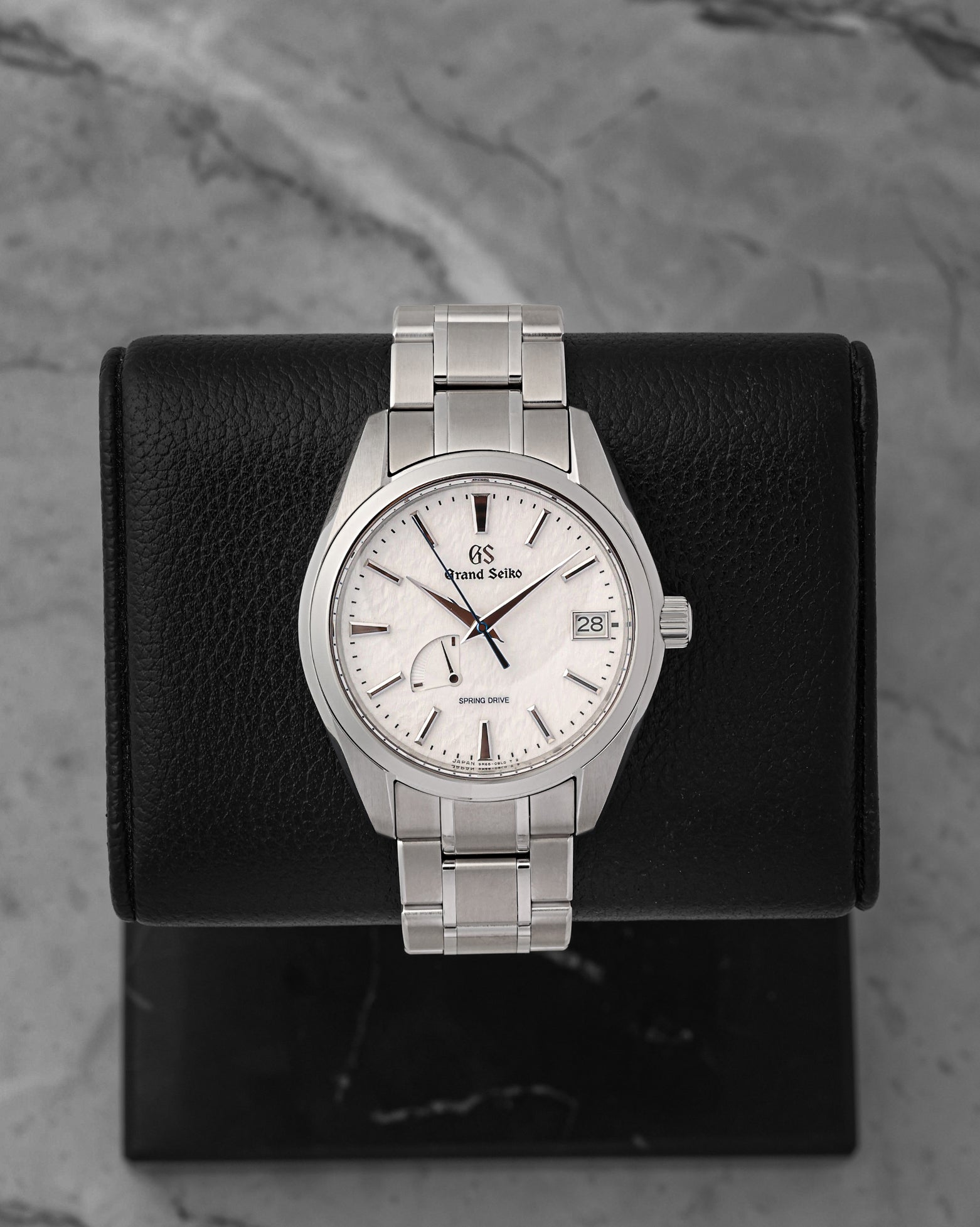 A pre-owned Grand Seiko Heritage Collection Snowflake reference SBGA211 showcasing its legendary wind-swept snow textured dial and a heat-blued steel seconds hand at Noah's Fine Watches & Jewelry in Dallas