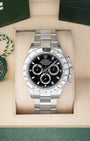 Preowned Rolex Cosmograph Daytona 116520 stainless steel watch with black dial and steel tachymeter bezel at Noah's Fine Watches and Jewelry Dallas Texas