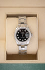 A ladies' pre-owned Rolex Lady-Datejust 26 reference 179384 featuring a black sunburst dial, factory diamond hour markers, and a diamond-set bezel inside its box at Noah's Fine Watches & Jewelry in Dallas