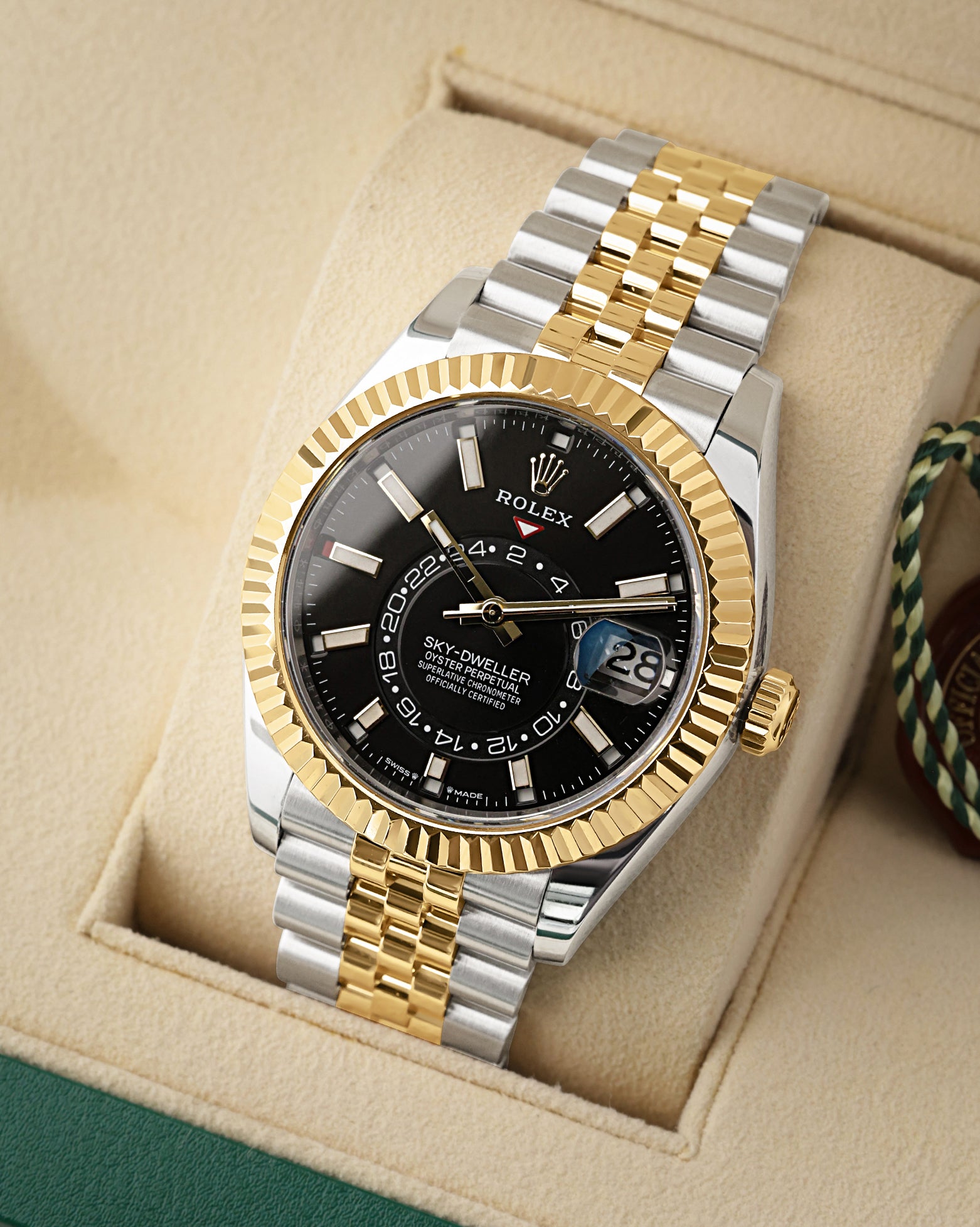 angled view of the 42mm Rolex Sky-Dweller 336933 showing the dual time zone off-center disc, Saros annual calendar, and 18k yellow gold Ring Command bezel