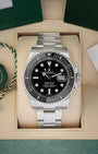 A pre-owned Rolex Submariner Date reference 116610LN featuring a glossy black dial, maxi markers, and a black Cerachrom ceramic bezel inside its box at Noah's Fine Watches & Jewelry in Dallas