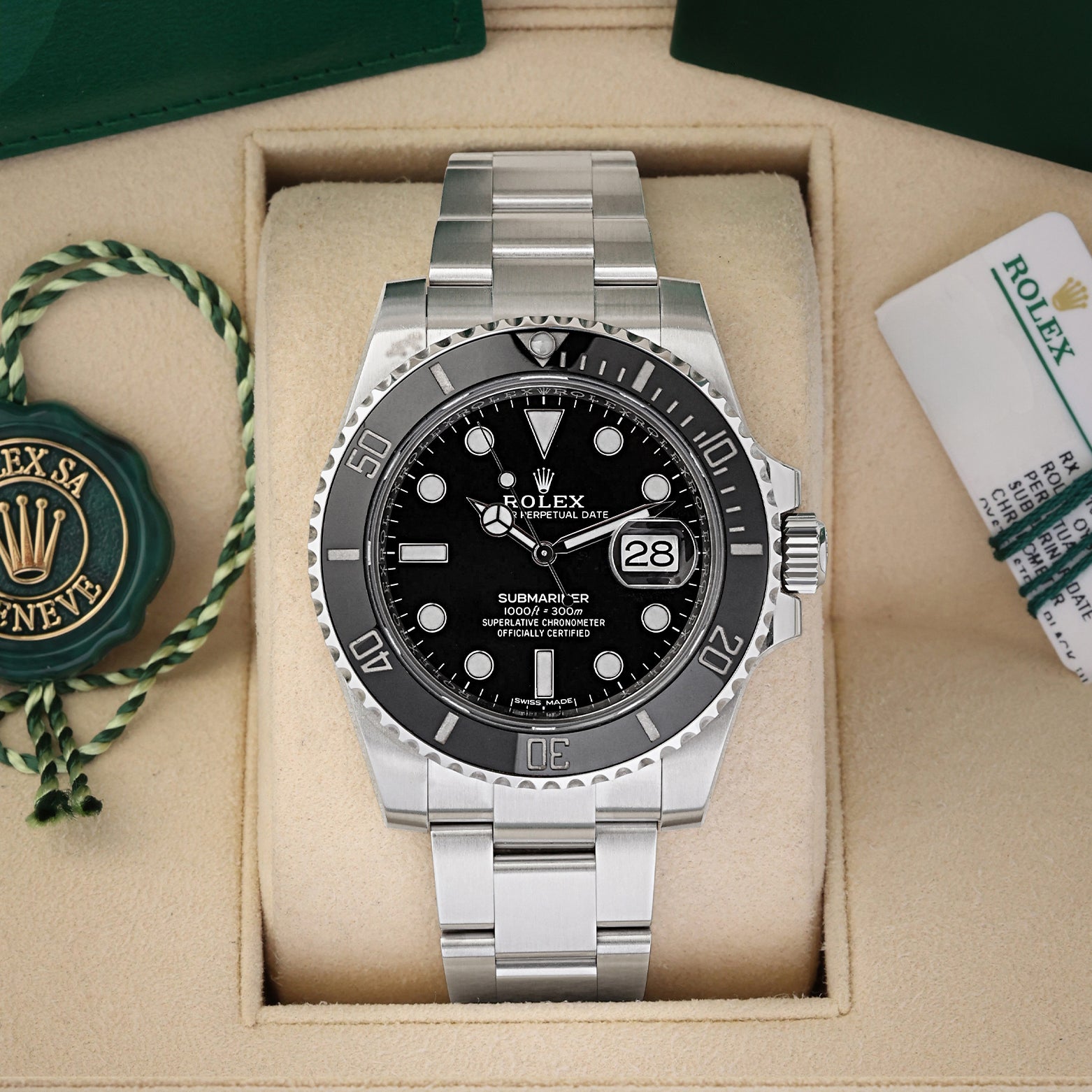 A pre-owned Rolex Submariner Date reference 116610LN featuring a glossy black dial, maxi markers, and a black Cerachrom ceramic bezel inside its box at Noah's Fine Watches & Jewelry in Dallas