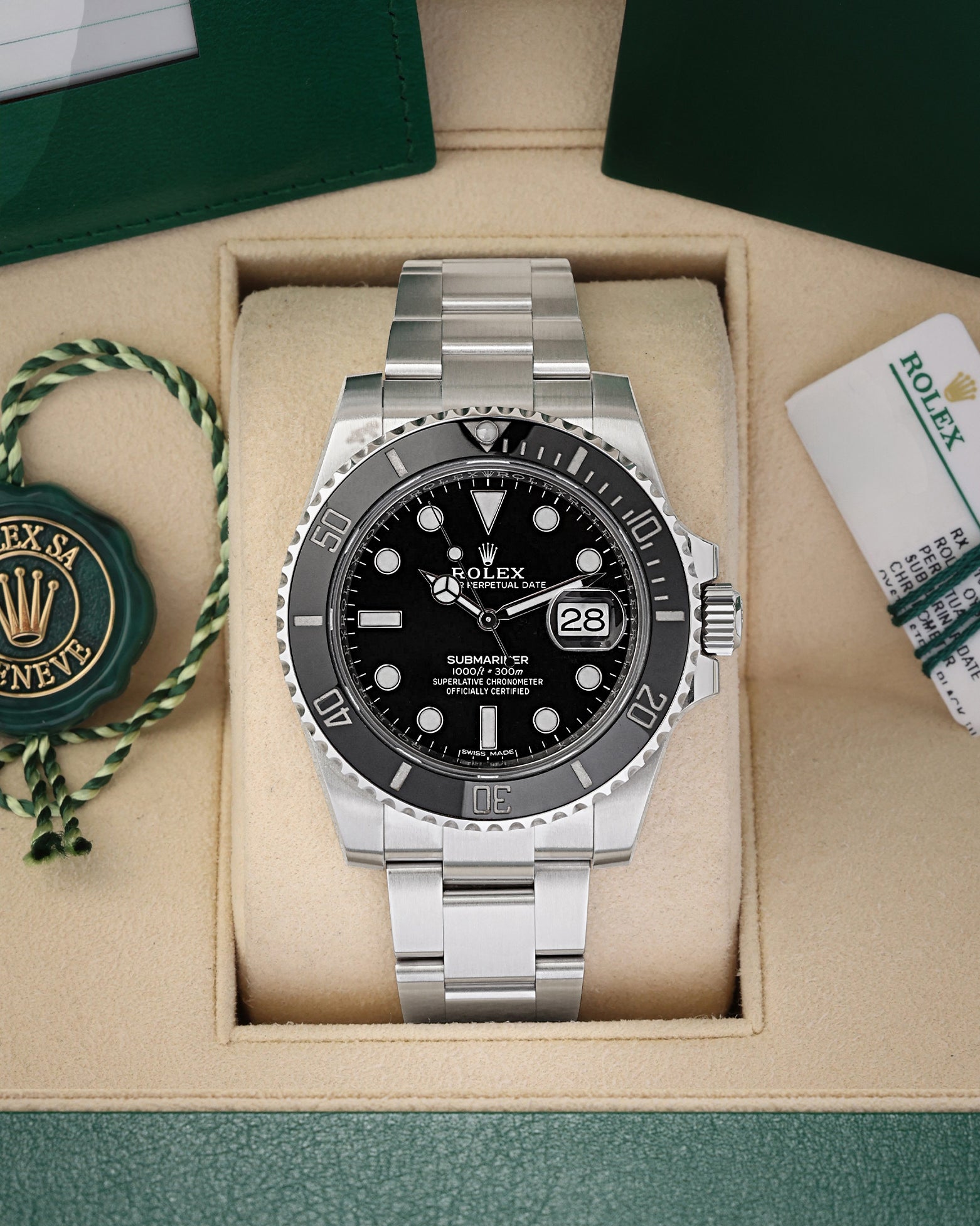 A pre-owned Rolex Submariner Date reference 116610LN featuring a glossy black dial, maxi markers, and a black Cerachrom ceramic bezel inside its box at Noah's Fine Watches & Jewelry in Dallas