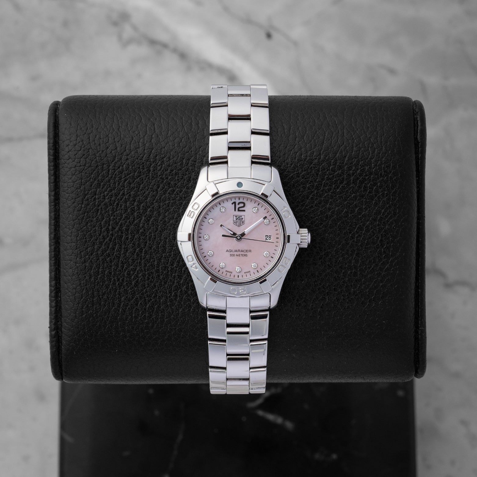 Preowned TAG Heuer Aquaracer 27mm WAF141A.BA0824 ladies stainless steel luxury watch featuring a pink Mother of Pearl dial and 10 diamond hour markers at Noah's Fine Watches and Jewelry in Dallas