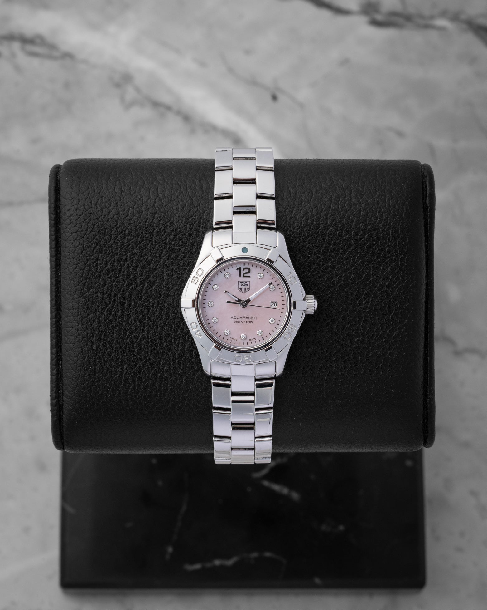 Preowned TAG Heuer Aquaracer 27mm WAF141A.BA0824 ladies stainless steel luxury watch featuring a pink Mother of Pearl dial and 10 diamond hour markers at Noah's Fine Watches and Jewelry in Dallas